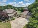 Inviting home with a spacious driveway and attached three-car garage, surrounded by lush greenery and trees at 105 Whippoorwill Way, Fayetteville, GA 30215
