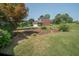 Beautiful home exterior with lush landscaping, mature trees, and a well-manicured lawn offering serene views at 105 Whippoorwill Way, Fayetteville, GA 30215