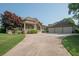Well-maintained home featuring lush green lawn and a three-car garage with ample parking space at 105 Whippoorwill Way, Fayetteville, GA 30215