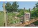 Inviting garden with a decorative gate, raised garden beds, and flourishing plants showcasing outdoor beauty at 105 Whippoorwill Way, Fayetteville, GA 30215