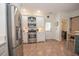 Kitchen features stainless appliances, white cabinets, and tile flooring at 105 Whippoorwill Way, Fayetteville, GA 30215