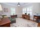 Comfortable living room with wood floors, natural light, and a floral patterned rug at 105 Whippoorwill Way, Fayetteville, GA 30215