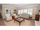 Living room featuring neutral tones, tile floors, and many windows providing natural light at 105 Whippoorwill Way, Fayetteville, GA 30215