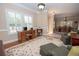 Inviting living room featuring a classic rug, hardwood floors, and natural light at 105 Whippoorwill Way, Fayetteville, GA 30215