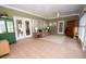 Bright and open sunroom with tile flooring, multiple windows, and comfortable furniture at 105 Whippoorwill Way, Fayetteville, GA 30215