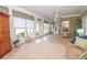 Bright sunroom featuring tile flooring, large windows, and neutral decor with a light-filled atmosphere at 105 Whippoorwill Way, Fayetteville, GA 30215