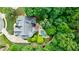 Aerial view of house, pool, and extensive landscaping surrounded by mature trees at 2101 Hunters Green Dr, Lawrenceville, GA 30043