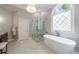 Bright bathroom featuring a modern tub, walk-in shower, and elegant finishes at 2101 Hunters Green Dr, Lawrenceville, GA 30043