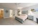 Bright, neutral bedroom with a ceiling fan and ensuite bathroom has ample room at 2101 Hunters Green Dr, Lawrenceville, GA 30043
