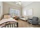This is a bedroom with a bed, crib, chair, and window at 2101 Hunters Green Dr, Lawrenceville, GA 30043