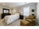 Comfortable bedroom featuring neutral colors, a ceiling fan and plush chair for relaxation at 2101 Hunters Green Dr, Lawrenceville, GA 30043