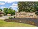 Stone Creek community sign surrounded by flowers and lawn at 2101 Hunters Green Dr, Lawrenceville, GA 30043