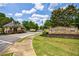 Stone Creek gated entrance with lush landscaping and well-manicured lawn at 2101 Hunters Green Dr, Lawrenceville, GA 30043