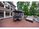 Outdoor deck with beautiful wooden floor features an outdoor dining set and a cozy couch at 2101 Hunters Green Dr, Lawrenceville, GA 30043