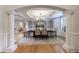 Formal dining room with hardwood floors, elegant lighting, and views of the living spaces at 2101 Hunters Green Dr, Lawrenceville, GA 30043