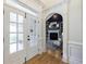 Elegant entryway with glass paneled door, archway to study, and gleaming hardwood flooring at 2101 Hunters Green Dr, Lawrenceville, GA 30043
