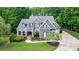 Beautiful two-story home with lush green lawn, mature trees, and an elegant exterior design at 2101 Hunters Green Dr, Lawrenceville, GA 30043