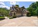 Spacious home featuring a three-car garage, long driveway, and beautifully landscaped front yard at 2101 Hunters Green Dr, Lawrenceville, GA 30043