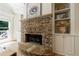 Stone fireplace with hearth, built-in shelves and hardwood floors at 2101 Hunters Green Dr, Lawrenceville, GA 30043