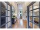 Elegant foyer with hardwood floors, high ceilings, glass panel doors, and views into the living spaces at 2101 Hunters Green Dr, Lawrenceville, GA 30043
