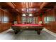 Custom game room with a coffered wood ceiling features a pool table with red felt at 2101 Hunters Green Dr, Lawrenceville, GA 30043