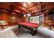 Custom game room with a coffered wood ceiling features a pool table with red felt at 2101 Hunters Green Dr, Lawrenceville, GA 30043