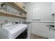 Laundry room with washer, dryer and open shelves at 2101 Hunters Green Dr, Lawrenceville, GA 30043