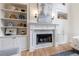 Bright living room with white fireplace, mantel, and built-in shelving on either side of the fireplace at 2101 Hunters Green Dr, Lawrenceville, GA 30043