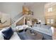 Spacious living room with soaring ceilings, hardwood floors, staircase and multiple seating areas at 2101 Hunters Green Dr, Lawrenceville, GA 30043