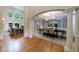 Open concept living and dining area featuring hardwood floors, columns, and abundant natural light at 2101 Hunters Green Dr, Lawrenceville, GA 30043