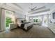 Spacious main bedroom featuring tray ceilings, large windows, and a sitting area at 2101 Hunters Green Dr, Lawrenceville, GA 30043