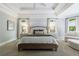 Bright main bedroom with tray ceiling, neutral tones, and view of the outdoors at 2101 Hunters Green Dr, Lawrenceville, GA 30043