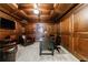 Cozy wood-paneled office with coffered ceilings features a desk and comfortable leather seating at 2101 Hunters Green Dr, Lawrenceville, GA 30043