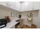 Home office with desk, chair, overhead cabinets and hardwood floors at 2101 Hunters Green Dr, Lawrenceville, GA 30043