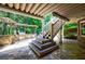 Outdoor patio with kitchen, seating, and stairs leading up to the deck area at 2101 Hunters Green Dr, Lawrenceville, GA 30043