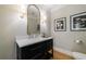 Chic powder room featuring a sleek vanity with modern fixtures and decorative art at 2101 Hunters Green Dr, Lawrenceville, GA 30043