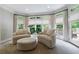 Cozy sitting area with comfortable chairs, ottoman, and natural light from the bay window at 2101 Hunters Green Dr, Lawrenceville, GA 30043