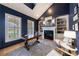 Cozy study with blue walls, built-in bookcases, fireplace, and stylish furniture at 2101 Hunters Green Dr, Lawrenceville, GA 30043