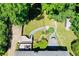 Expansive backyard featuring lush landscaping, fire pit, patio seating, and mature trees at 290 Dania Dr, Alpharetta, GA 30009