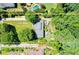 An aerial view showing the home's 1+/- acre lot with a long driveway, landscaping, and a pool in the neighboring property at 290 Dania Dr, Alpharetta, GA 30009