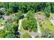 Aerial view of a property featuring lush landscaping, a swimming pool, and mature trees at 290 Dania Dr, Alpharetta, GA 30009