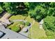 Lush backyard features mature trees, patio seating, a shed, and a peaceful ambiance at 290 Dania Dr, Alpharetta, GA 30009