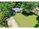 Aerial view featuring a meticulously maintained lawn and inviting single-story home, surrounded by nature at 290 Dania Dr, Alpharetta, GA 30009