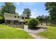 Landscaped backyard with a quaint gazebo, stone walkways, and lush green lawn at 290 Dania Dr, Alpharetta, GA 30009