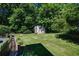 Spacious backyard featuring a shed, lush greenery, and a well-maintained lawn, ideal for outdoor enjoyment at 290 Dania Dr, Alpharetta, GA 30009