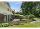 Exterior featuring a beautiful garden, patio set, and manicured lawn at 290 Dania Dr, Alpharetta, GA 30009