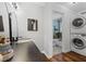 Modern bathroom featuring a stylish vanity, stackable washer/dryer, and access to a separate toilet and shower area at 290 Dania Dr, Alpharetta, GA 30009