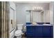 Bathroom showcasing a blue vanity, large mirror, and a combined tub and shower with a curtain at 290 Dania Dr, Alpharetta, GA 30009