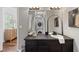 Stylish bathroom with a black vanity, vessel sink, arched mirror, and a stacked washer/dryer at 290 Dania Dr, Alpharetta, GA 30009