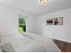 Cozy bedroom with a large window, hardwood floors, and minimalist decor at 290 Dania Dr, Alpharetta, GA 30009